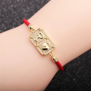 Red braided rope bracelet with golden heart lock and key charm set with white zircon