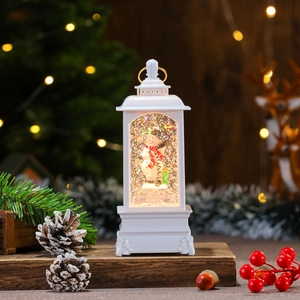 Close-up of a white musical Christmas snow globe lantern with snowman and warm LED light