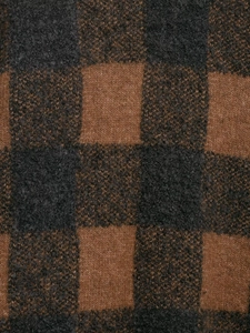Macro shot of brown and black checkerboard knit fabric texture for fashion sweater