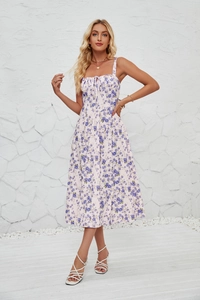 Detail view of floral print sleeveless dress featuring a side slit and elegant patterns