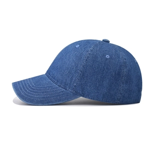 Close-up of side view showing distressed denim texture and stitching on the baseball cap