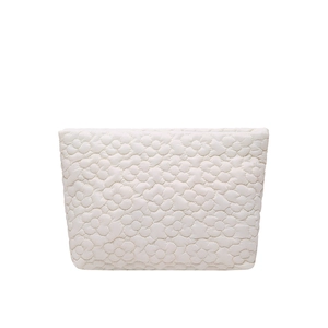 Minimalist white quilted floral makeup bag with textured flower pattern and zipper