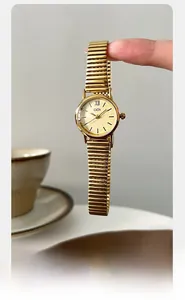 Detail of vintage gold women watch with unique elastic expansion band and round dial