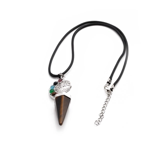 Macro shot of silver Tree of Life charm and tiger eye crystal pendant on a black cord necklace