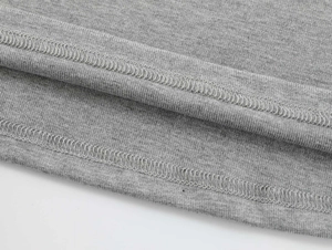 Macro view of double-needle stitching and hem detail on grey modal sports t-shirt