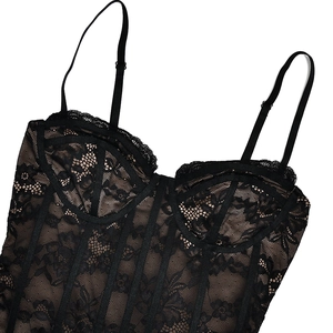 Close-up of black lace corset top featuring underwire cups and vertical boning details