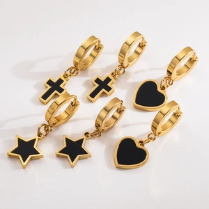 Three pairs of gold stainless steel huggie earrings with black cross heart and star charms