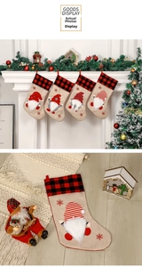 Detail of burlap Christmas stockings featuring red buffalo plaid and 3D gnome appliques