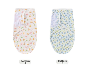 Detail of soft newborn swaddle wraps featuring cartoon giraffe and elephant prints