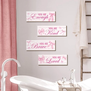 Set of four farmhouse wood wall signs with pink bows and inspirational quotes for home decor