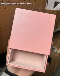 Macro view of pink pearlescent paper jewelry drawer box with soft velvet lining