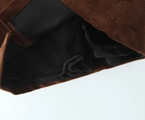 Detail shot of brown corduroy skirt showing premium black lining and neat stitching