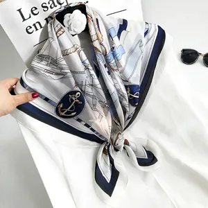 Detail of nautical 90cm silk scarf with anchor and ship patterns in blue and white