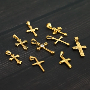 Selection of eight unique 18K gold plated titanium steel cross pendants with zircon accents