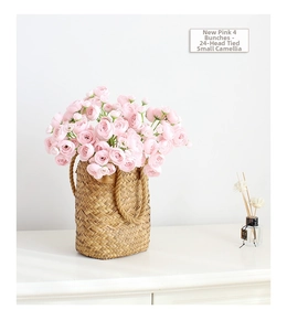 Detail of 4 bundles of pink silk camellias with 24 heads in a woven decorative basket