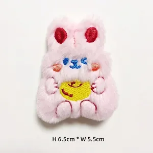 Close-up of pink plush bunny brooch with red embroidery details, size 6.5cm by 5.5cm