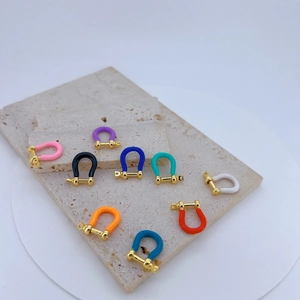 Close-up of colorful enamel U-shape horseshoe clasps for DIY jewelry making