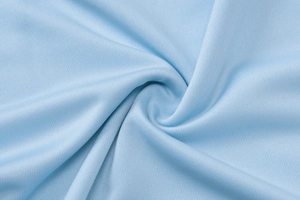 Detailed close-up of light blue vertical ribbed knit fabric texture and soft material