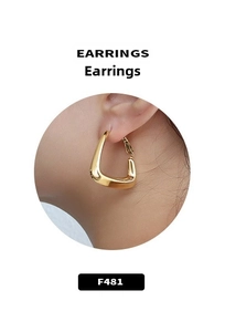 Close-up of minimalist golden irregular hoop earrings with polished finish on model ear