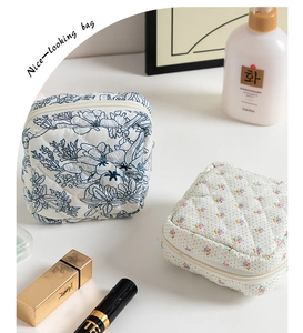 Detailed close-up of quilted floral cosmetic bags with lotion and lipstick accessories