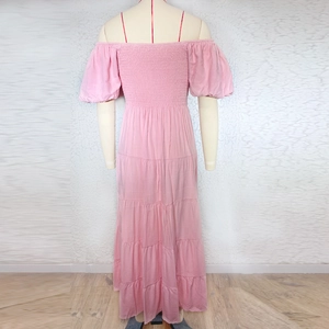 Back view of pink off-shoulder maxi dress with puff sleeves and layered cake hem
