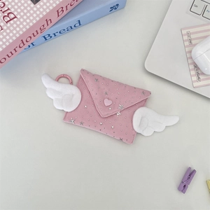 Close-up of pink envelope coin purse with white plush wings and silver star details