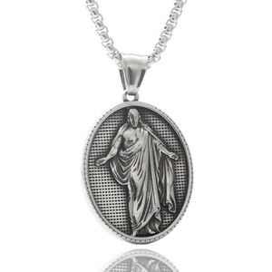 Macro detail of oval stainless steel pendant featuring a classic relief portrait and box chain