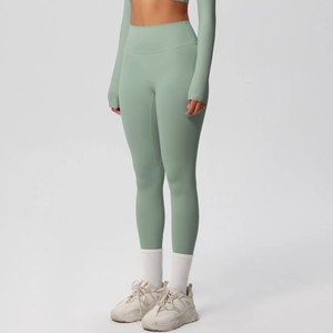 Detailed texture of seamless high-waisted yoga leggings in light green knitted fabric
