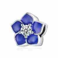 Detail of silver floral bead with blue enamel petals and sparkling center zircon