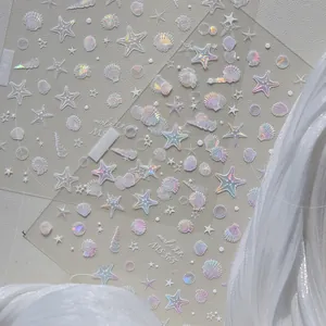 Close-up of 3D shell and starfish nail stickers with iridescent laser finish