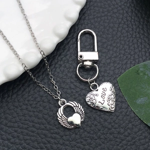 Vintage silver heart jewelry set with winged pendant and love engraved keychain