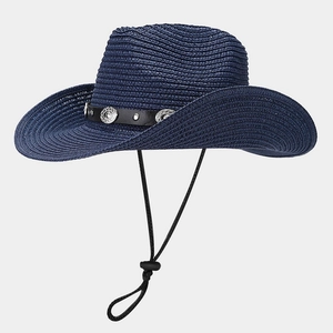 Detail of dark blue straw hat featuring silver metal studs and adjustable wind lanyard