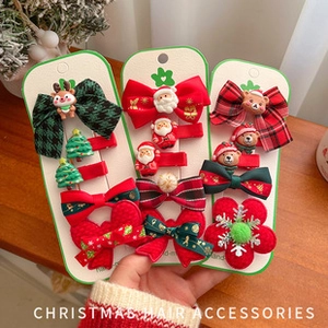 Detail of handmade Christmas hair accessory set with festive reindeer and Santa motifs