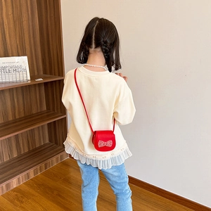 Red crossbody bag for girls featuring cute pearl bow decoration on saddle flap