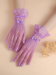 Detail of purple lace mesh bridal gloves with bow tie and pearl accents
