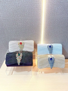Sparkly crystal clutch bags with peacock rhinestones in silver, black, blue, and gold colors