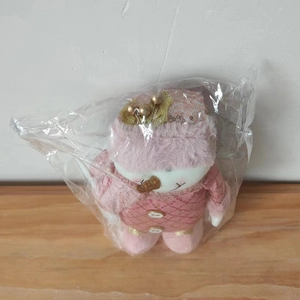 Detailed view of plush pink Christmas snowman figurine with golden berry hat decorations