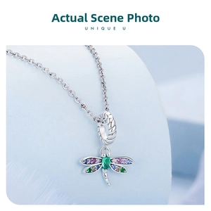 Detailed macro view of S925 sterling silver dragonfly charm with colorful zircon stones