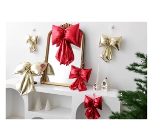 Detail showing red and gold metallic Christmas bows in large and small sizes for decor