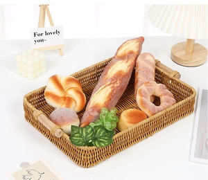 Detail of rectangular woven fruit basket with sturdy wooden handles and natural texture