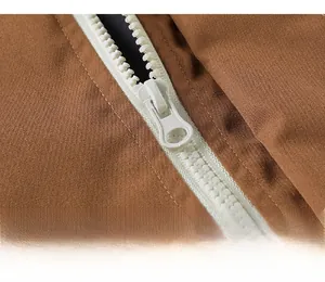 Macro detail of high-quality smooth white resin zipper on brown casual shorts