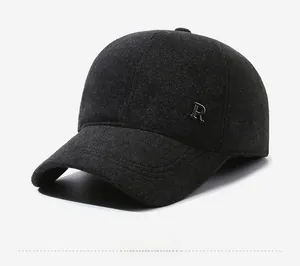 Close-up of dark grey wool baseball cap with metallic R logo and thick texture