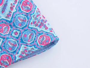 Detail of quilted cotton coat featuring blue and purple geometric ethnic print patterns