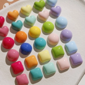 Macro view of colorful resin heart, round and square charms for DIY accessories