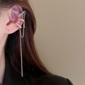Detail of silver layered ear cuff with sparkling zircon fringe and chains on model