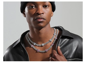 Detail of double-layered silver Cuban chain featuring alternating pink and clear heart diamonds