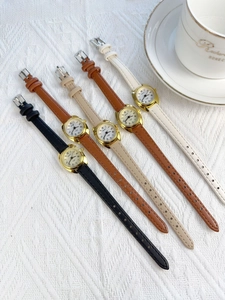 Five elegant women's quartz watches with leather straps and gold cases on white lace