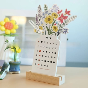 Detailed view of Bloomy Flowers wood calendar with colorful floral cutout design and base