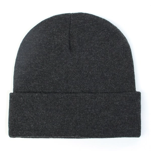 Close-up of dark grey knitted beanie showing detailed rib-knit texture and fold-over cuff