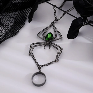 Gothic spider hand harness with green pear-shaped gemstone and black lace background